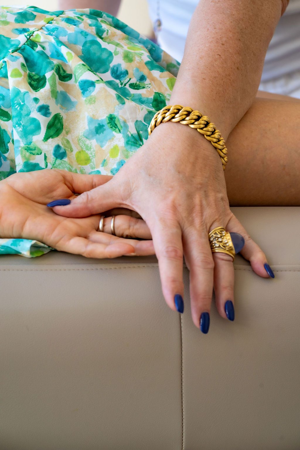 Juliette's hand resting over a client's hand